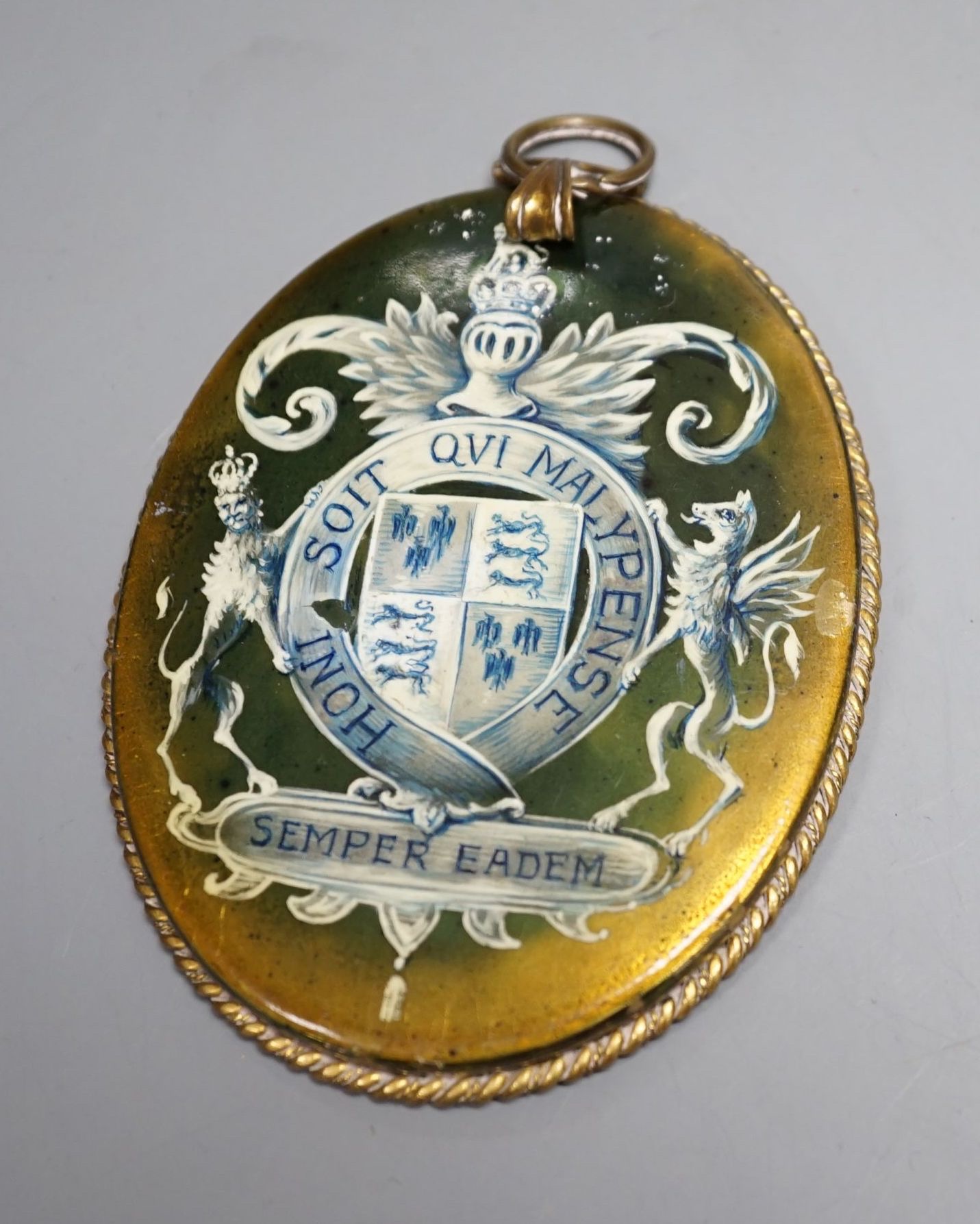 An Elizabeth I 1593 sixpence and a oval portrait frame the reverse depicting Elizabeth I coat of arms.
